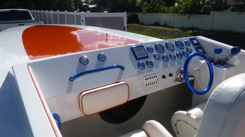Slide: The Image of 1971 Magnum Sport boat dashboard with blue and white controls and steering wheel. - 7