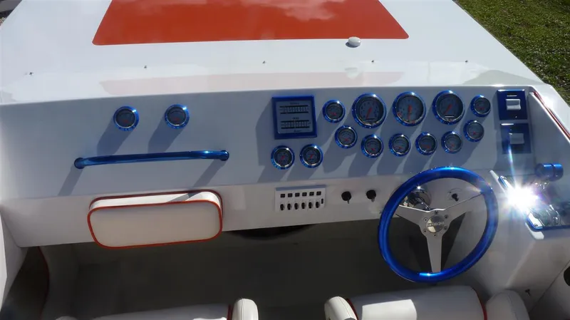 Slide: The Image of 1971 Magnum Sport boat dashboard with blue accents and multiple gauges. - 8