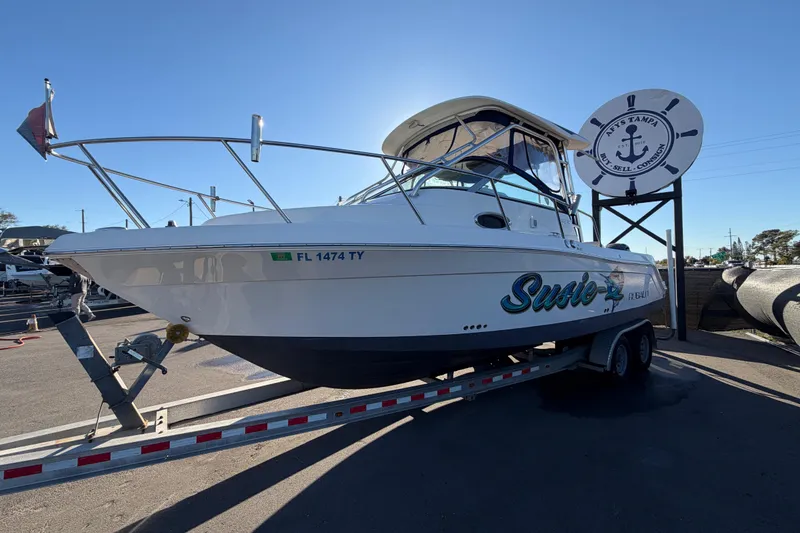 Slide: The Image of 2017 Robalo R265 Walkaround boat on trailer at dealership, sunny day. - 12