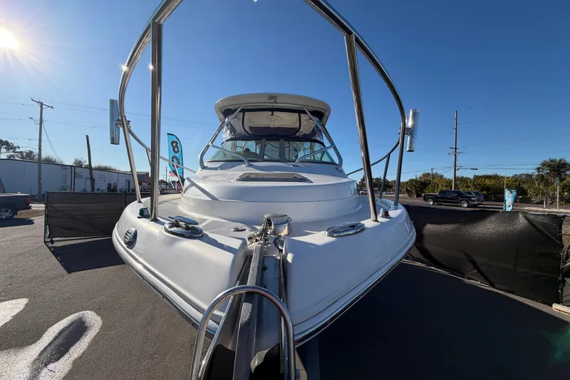 Slide: The Image of 2017 Robalo R265 Walkaround boat, front view, displayed outdoors under clear blue sky. - 14
