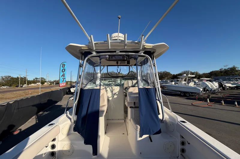 Slide: The Image of 2017 Robalo R265 Walkaround boat at a sales lot under clear blue sky. - 19