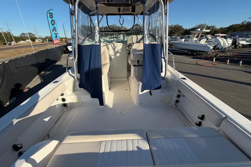 Slide: The Image of 2017 Robalo R265 Walkaround boat interior at a sale event, showcasing seating and helm area. - 20
