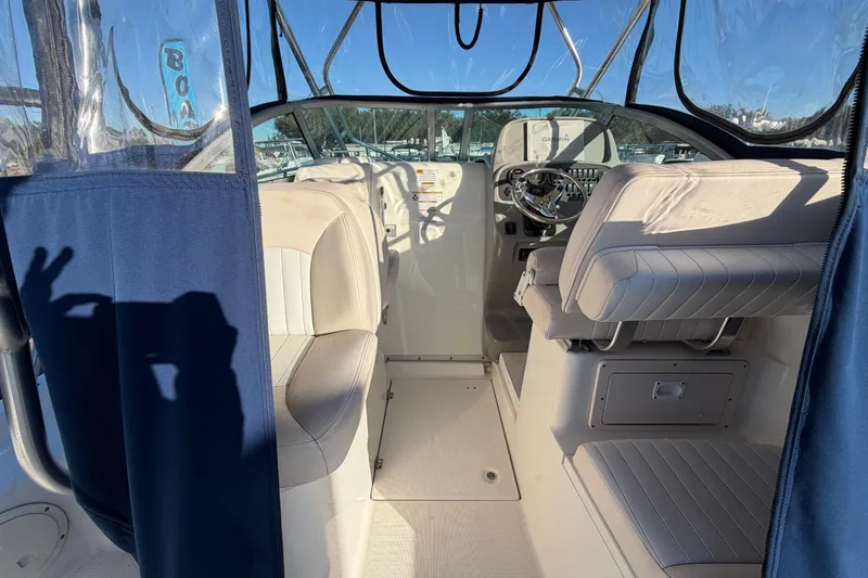 Slide: The Image of Interior of 2017 Robalo R265 Walkaround boat with seating and steering wheel. - 22