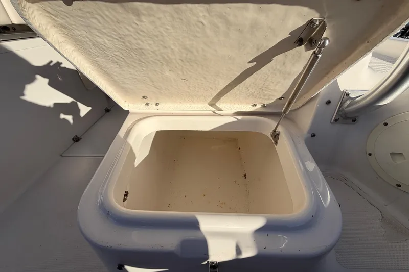Slide: The Image of Open storage compartment on 2017 Robalo R265 Walkaround boat, showing interior details. - 24
