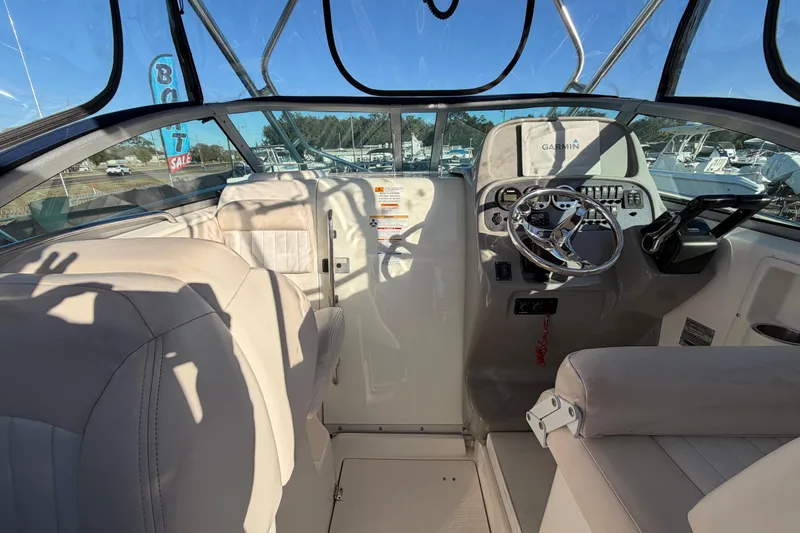 Slide: The Image of 2017 Robalo R265 Walkaround boat interior with steering wheel and seating. - 25