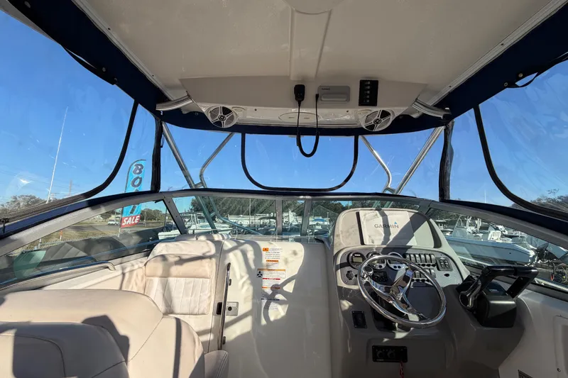 Slide: The Image of 2017 Robalo R265 Walkaround boat interior with steering wheel and navigation equipment. - 26