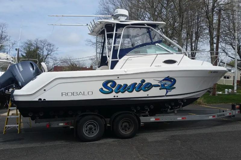 Slide: The Image of 2017 Robalo R265 Walkaround boat with Yamaha outboard motor, parked on a trailer. - 3