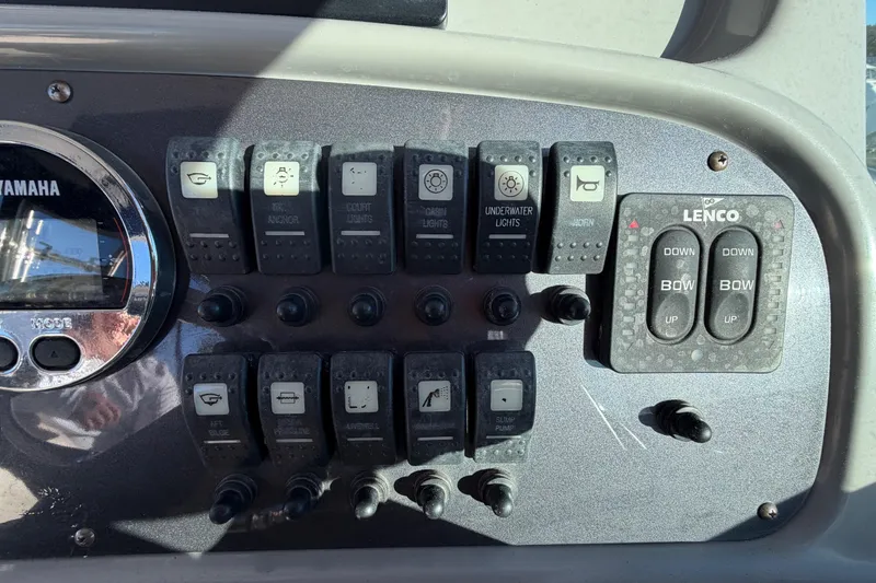 Slide: The Image of Control panel of a 2017 Robalo R265 Walkaround boat with Yamaha and Lenco switches. - 35