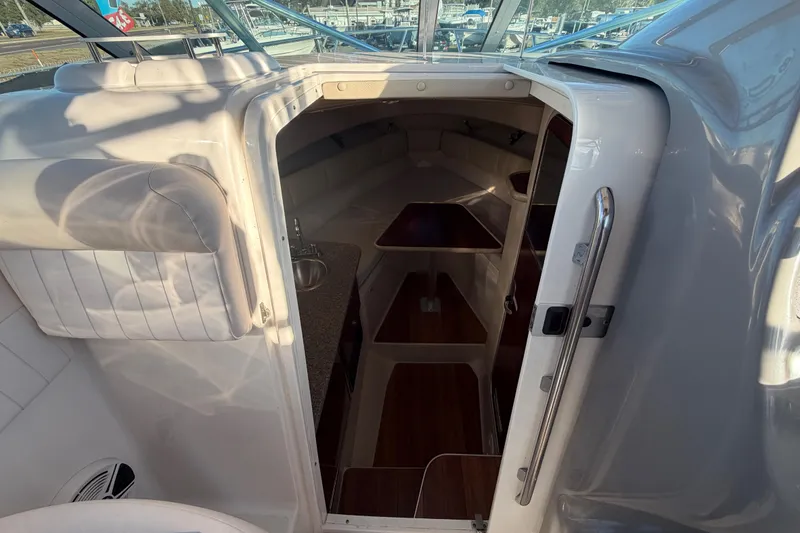 Slide: The Image of 2017 Robalo R265 Walkaround cabin interior with seating and kitchenette. - 38