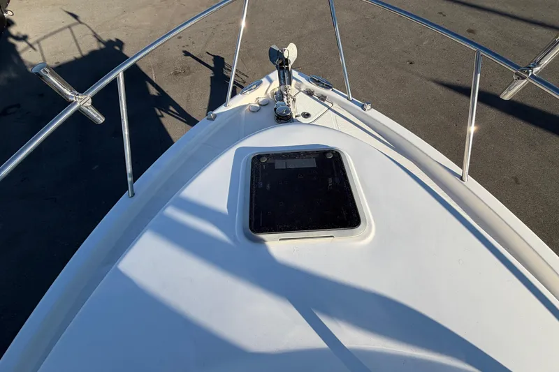 Slide: The Image of 2017 Robalo R265 Walkaround boat deck with hatch and railing. - 50