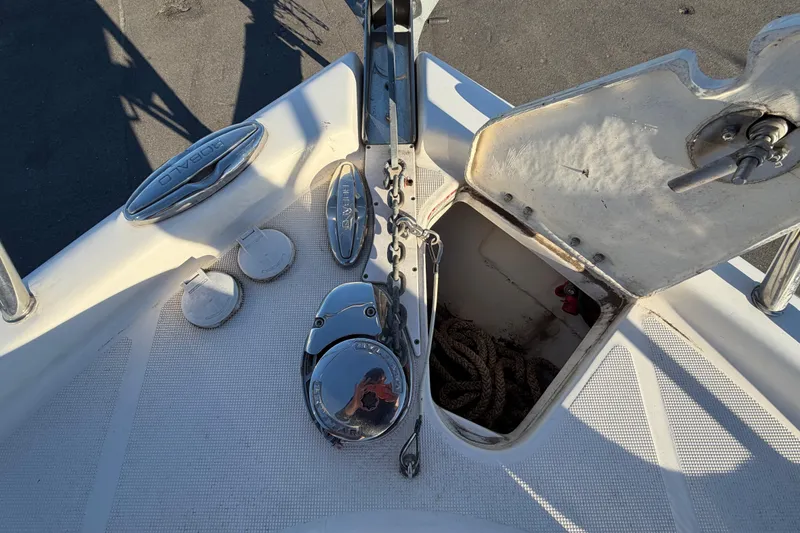 Slide: The Image of 2017 Robalo R265 Walkaround boat anchor compartment with open hatch and visible rope. - 52