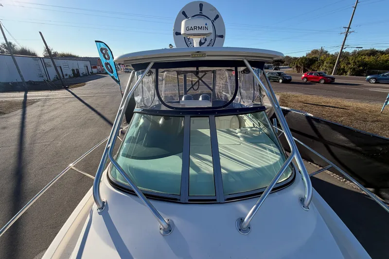 Slide: The Image of 2017 Robalo R265 Walkaround boat with Garmin radar, docked on a sunny day. - 55