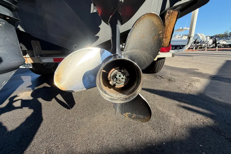 Slide: The Image of Propeller of 2017 Robalo R265 Walkaround boat on a trailer in a marina. - 6