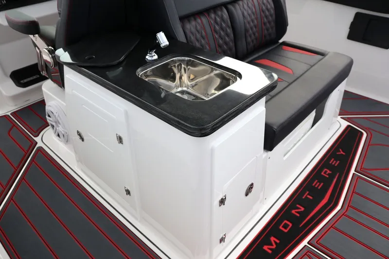 Slide: The Image of 2026 Monterey Elite 30 OB boat interior with sink and seating. - 16