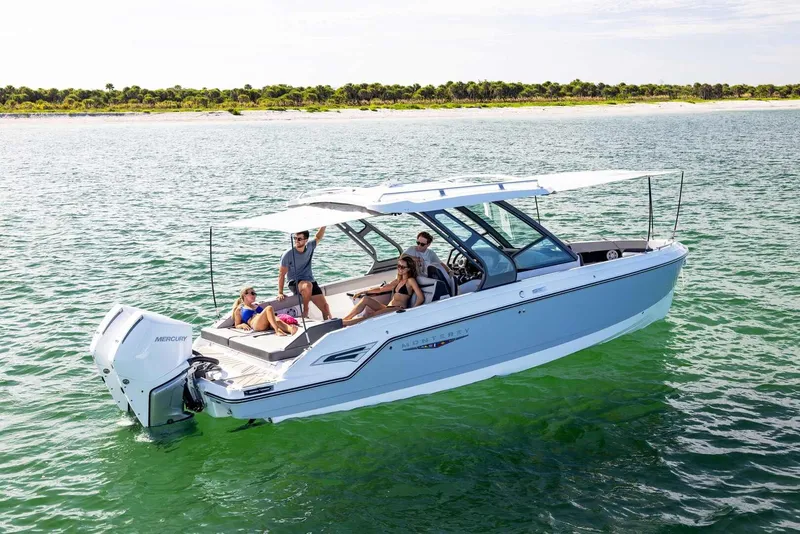 Slide: The Image of 2026 Monterey Elite 30 OB boat on water with passengers. - 32