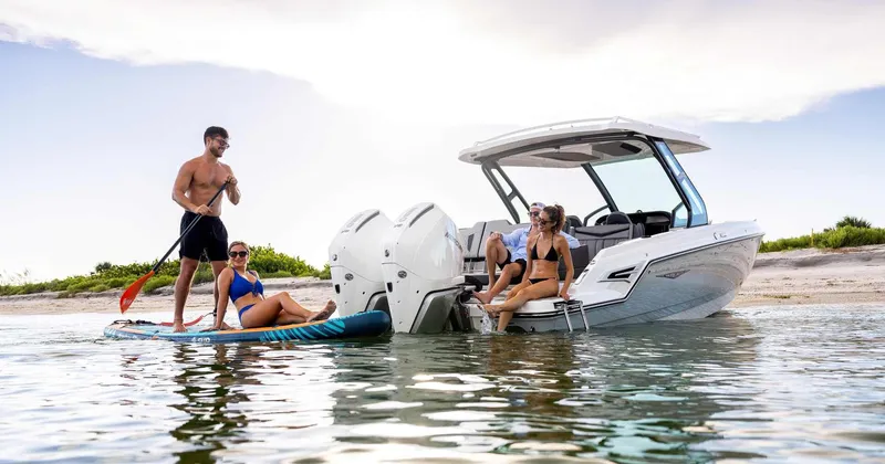 Slide: The Image of Monterey Elite 30 OB 2026 boat with people paddleboarding. - 39