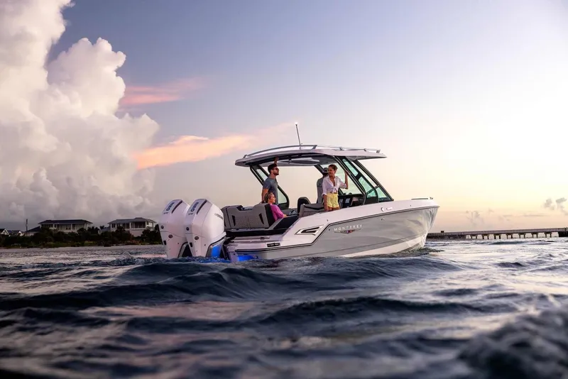 Slide: The Image of Monterey Elite 30 OB 2026 on calm waters at sunset. - 4