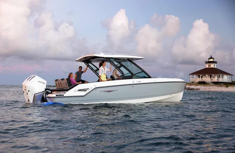 Slide: The Image of 2026 Monterey Elite 30 OB boat on water at sunset. - 41