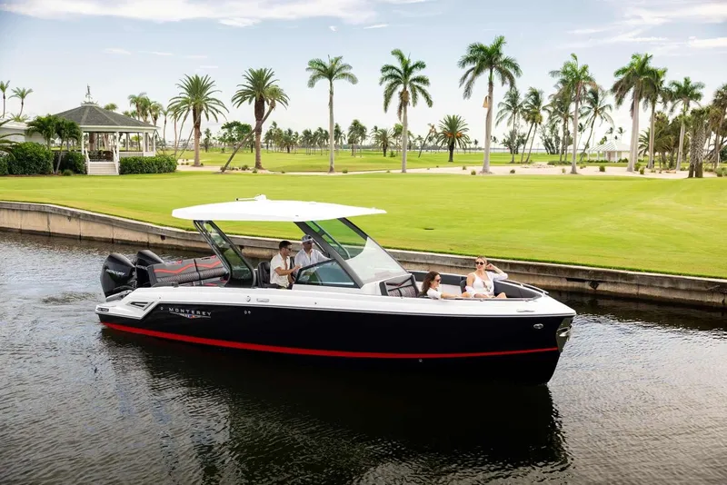 Slide: The Image of 2026 Monterey Elite 30 OB boat on water with palm trees in background. - 43