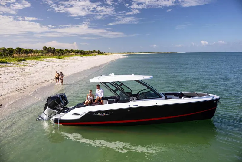 Slide: The Image of Monterey Elite 30 OB 2026 at beach with people on board. - 45