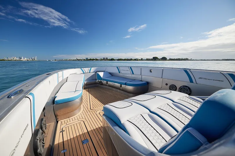 Slide: The Image of Luxurious Midnight Express 43' Open boat interior with plush seating, cruising on calm waters. - 11