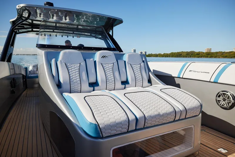 Slide: The Image of Luxury seating on a Midnight Express 43' Open boat, featuring sleek design and waterfront view. - 12