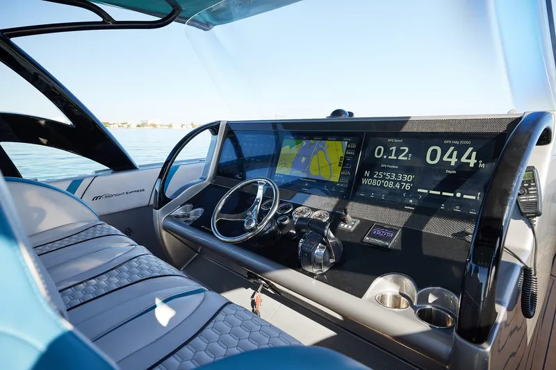 Slide: The Image of Midnight Express 43' Open boat cockpit with advanced navigation displays and steering wheel. - 15