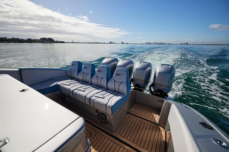 Slide: The Image of Luxury Midnight Express 43' Open boat cruising on calm waters, featuring powerful engines. - 18