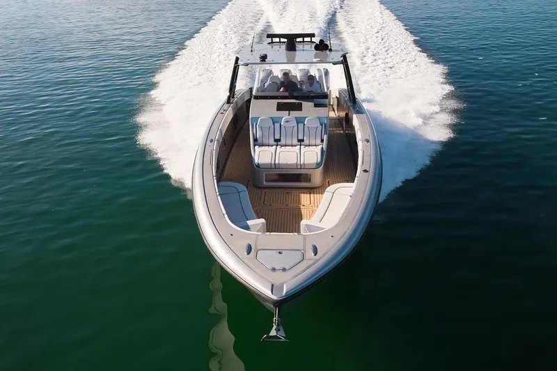 Slide: The Image of Midnight Express 43' Open boat cruising on clear water, showcasing sleek design and performance. - 2