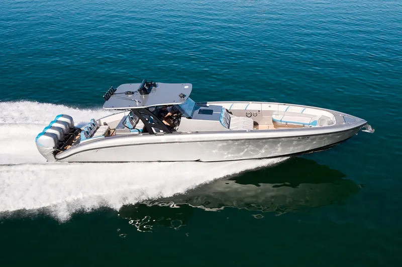 Slide: The Image of Midnight Express 43' Open boat cruising on clear blue water, showcasing sleek design and powerful engines. - 4