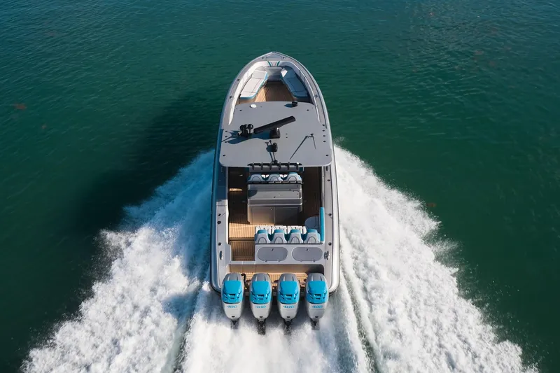 Slide: The Image of Midnight Express 43' Open boat cruising on water with four powerful engines. - 5