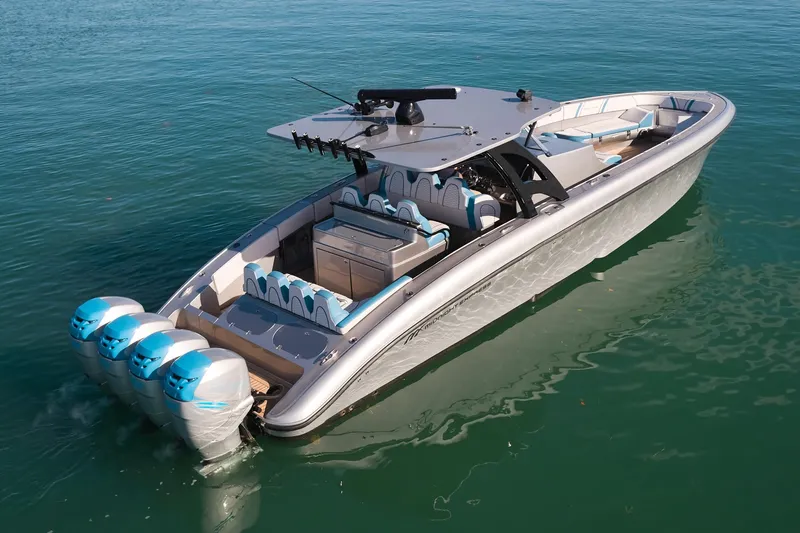 Slide: The Image of Luxury Midnight Express 43' Open boat with four powerful outboard engines on clear water. - 8
