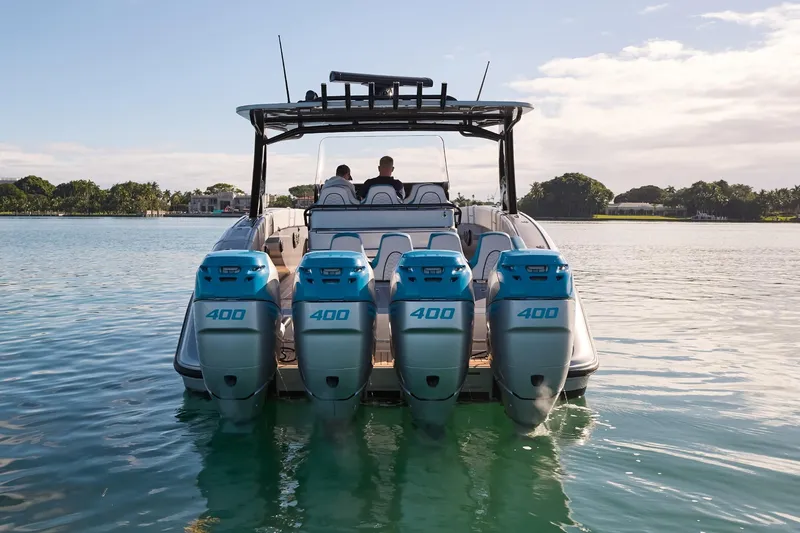 Slide: The Image of Midnight Express 43' Open boat with four powerful engines on calm water. - 9