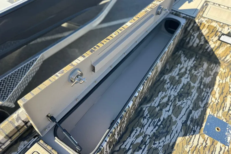 Slide: The Image of Open storage compartment in 2026 Avid 16 Commander boat with camouflage design. - 10