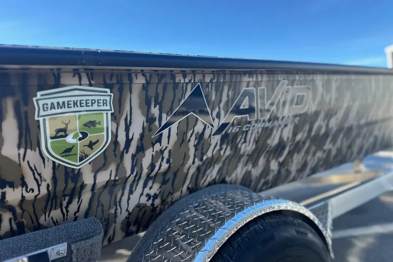 Slide: The Image of 2026 Avid 16 Commander boat with Gamekeeper logo and camouflage design. - 12