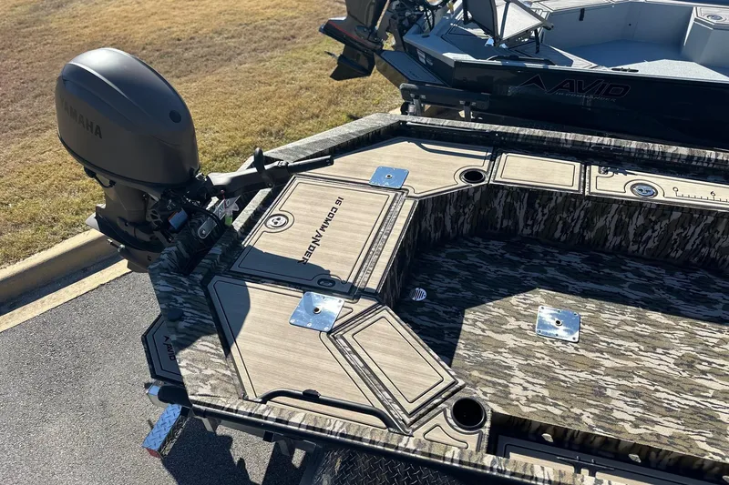 Slide: The Image of 2026 Avid 16 Commander boat with Yamaha motor, featuring camo design and deck storage. - 14