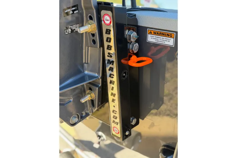 Slide: The Image of Close-up of Avid 16 Commander 2026 boat component with warning label and bolts. - 15