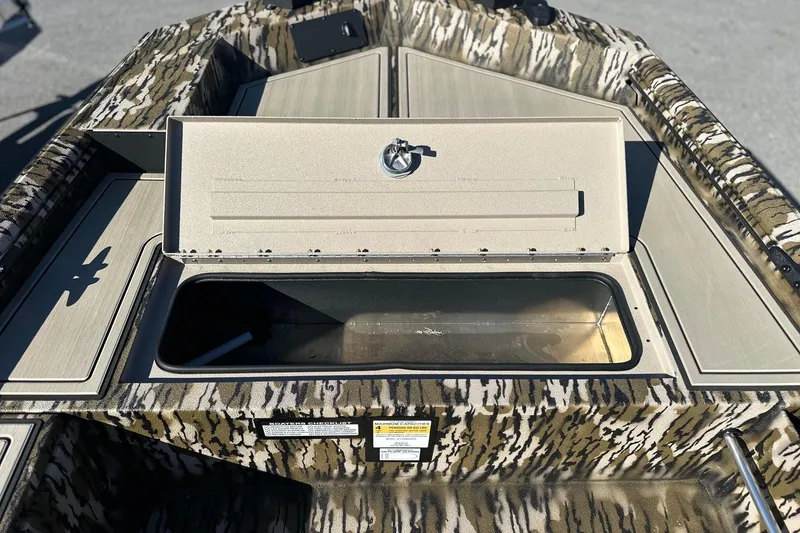 Slide: The Image of 2026 Avid 16 Commander boat with open storage compartment, camo design. - 6