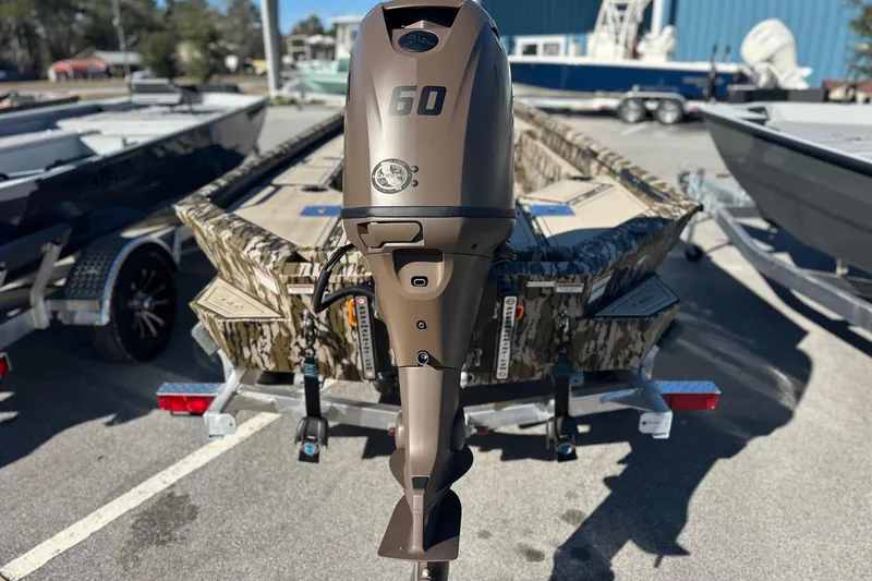 Slide: The Image of 2026 Avid 16 Commander boat with 60 HP outboard motor, camo design. - 7