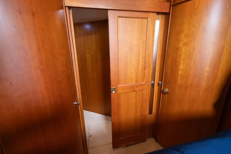 Slide: The Image of Interior view of 2001 Silverton 410 Sport Bridge with wooden doors and paneling. - 10