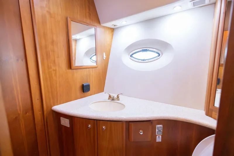 Slide: The Image of Luxurious bathroom interior of 2001 Silverton 410 Sport Bridge yacht with wooden cabinetry. - 11