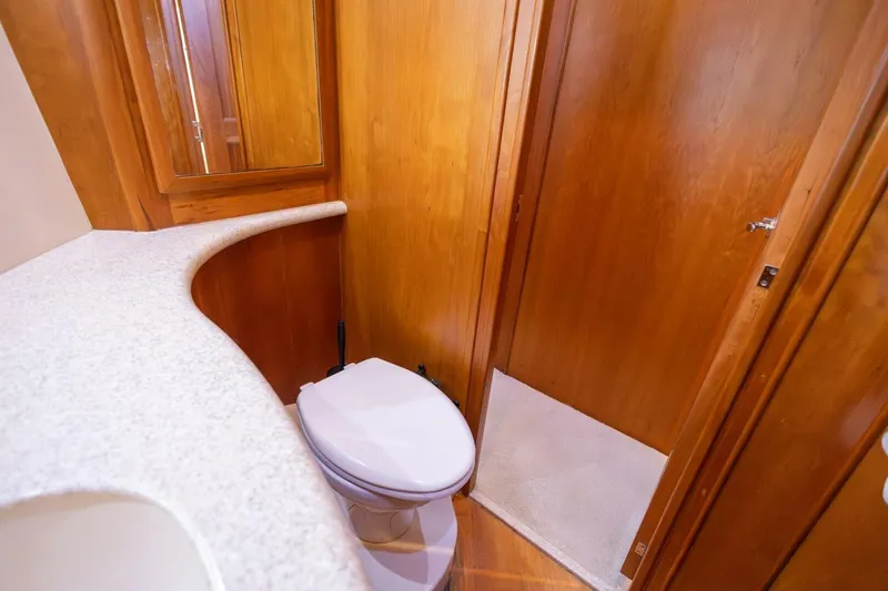 Slide: The Image of 2001 Silverton 410 Sport Bridge bathroom with wooden cabinetry and modern fixtures. - 12