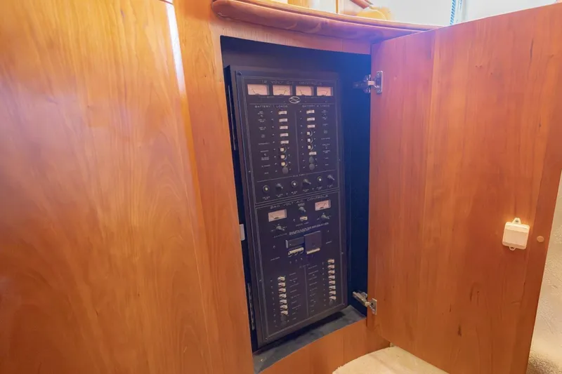 Slide: The Image of Electrical panel inside a 2001 Silverton 410 Sport Bridge yacht, wooden cabinet open. - 19