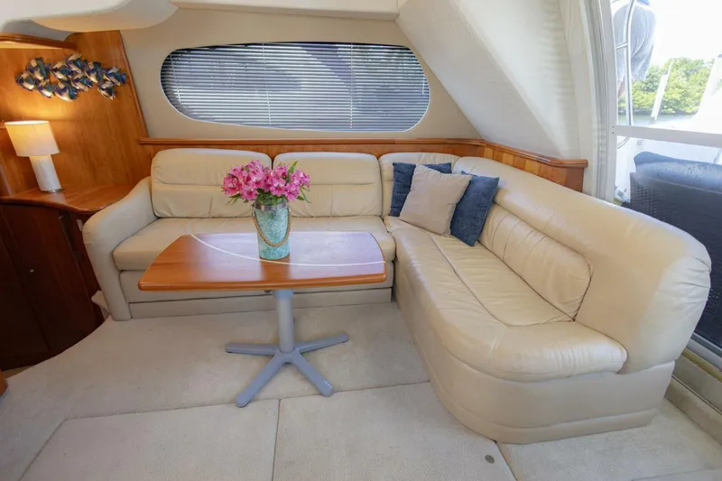 Slide: The Image of Luxurious interior of 2001 Silverton 410 Sport Bridge with cream leather seating and wooden table. - 20