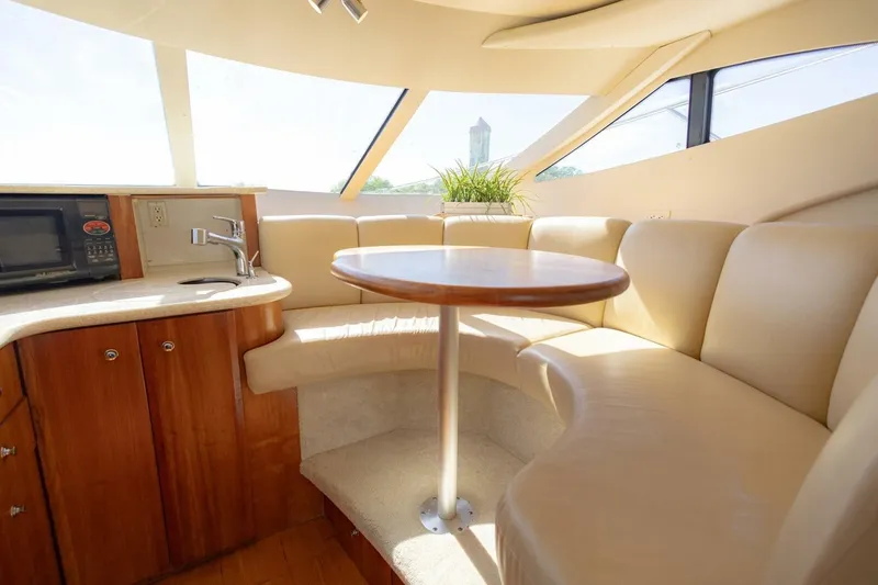 Slide: The Image of Interior of 2001 Silverton 410 Sport Bridge with cozy seating and kitchenette. - 24