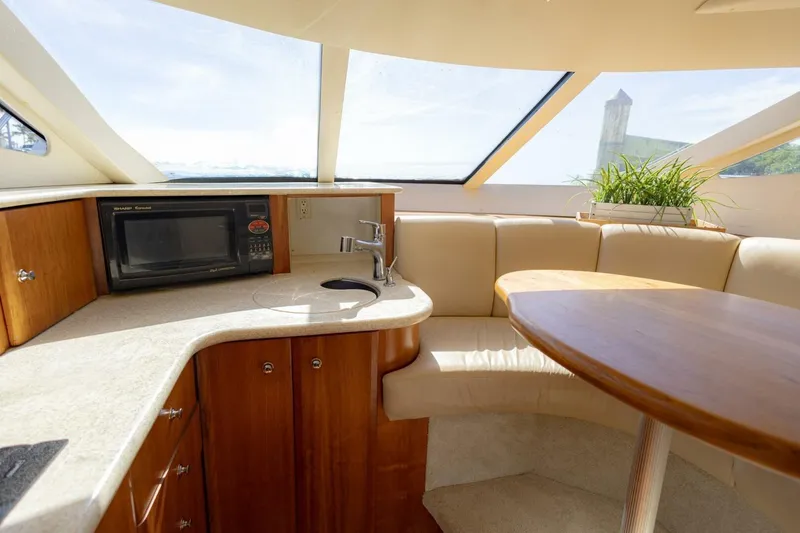 Slide: The Image of Interior of 2001 Silverton 410 Sport Bridge with kitchenette and seating area. - 27
