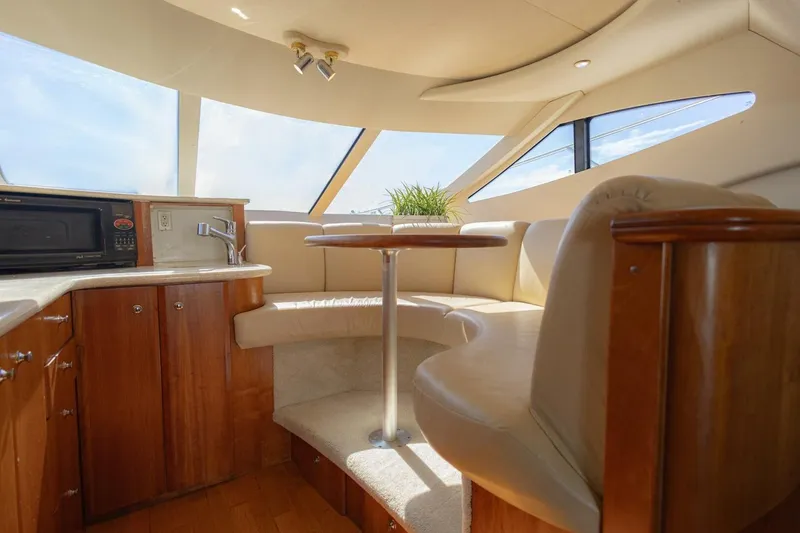 Slide: The Image of Interior of 2001 Silverton 410 Sport Bridge yacht with seating and kitchenette. - 30