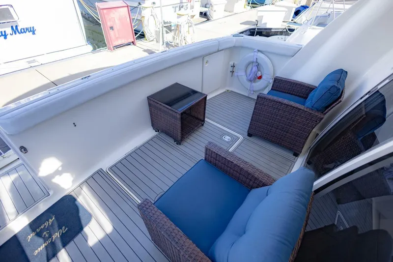 Slide: The Image of 2001 Silverton 410 Sport Bridge yacht deck with wicker chairs and table. - 36