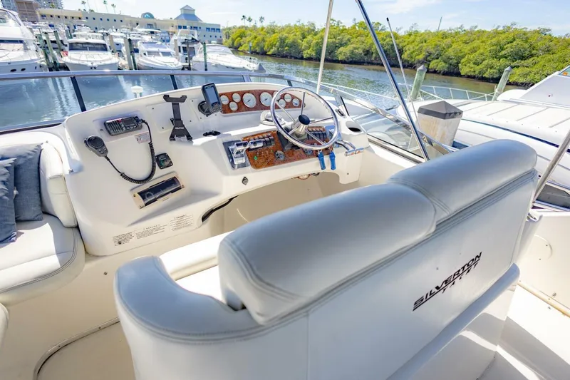 Slide: The Image of 2001 Silverton 410 Sport Bridge yacht helm with luxurious seating and modern controls. - 39