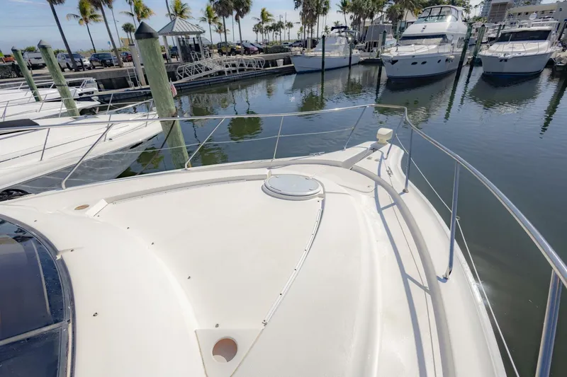 Slide: The Image of 2001 Silverton 410 Sport Bridge yacht docked at marina with palm trees. - 45